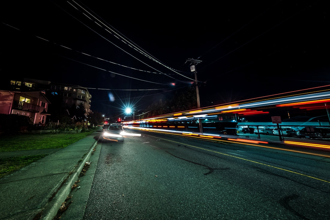 a car driving down a street at night