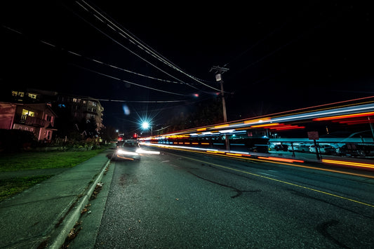 a car driving down a street at night