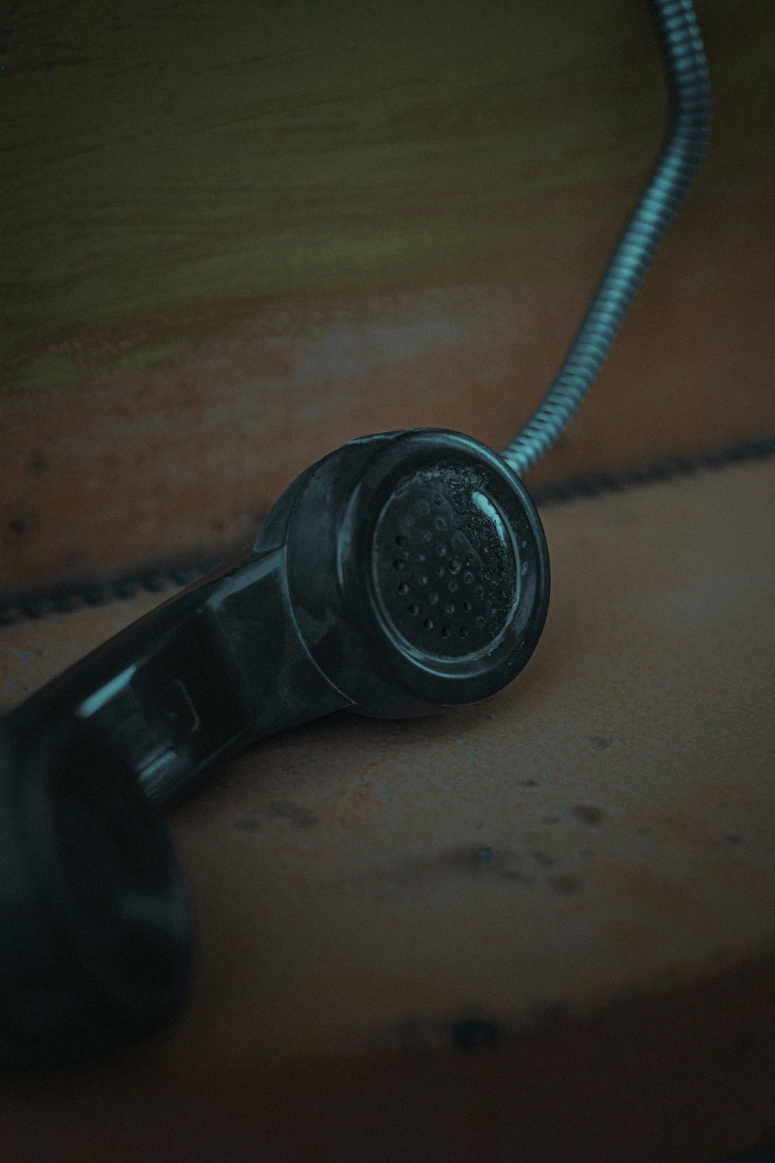 black corded telephone on brown wooden table